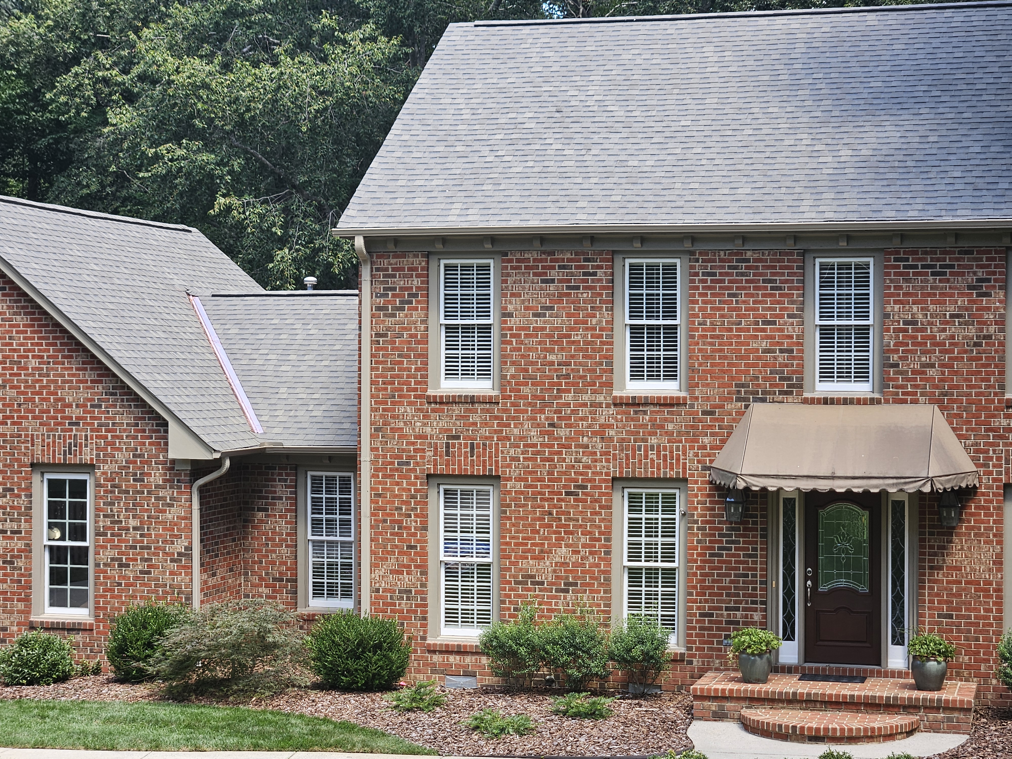 Real finished roof replacement on a brick home by Old Timers Roofing