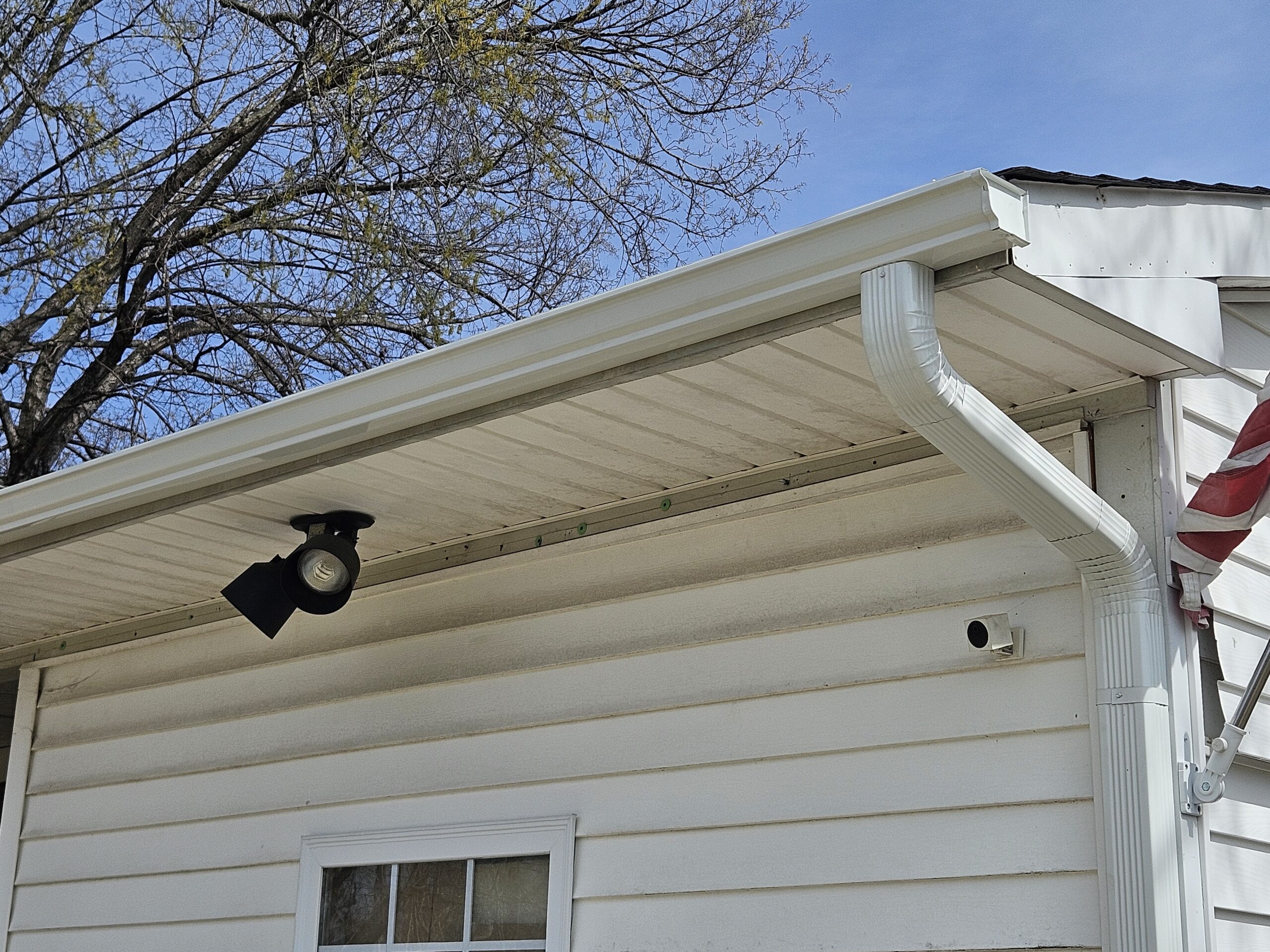 Close view of newly installed gutters on Greensboro veteran home by Old Timers Roofing